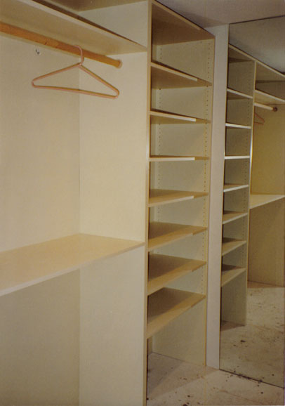 Closet with sliding doors and racks by Maurer Construction